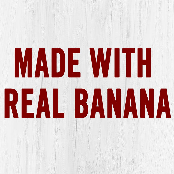 The words Made with Real Banana in red on a white wooden background.