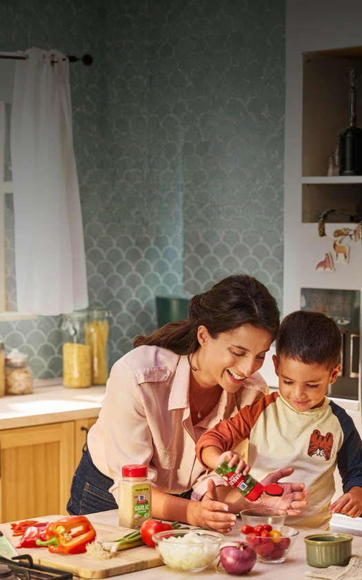 Woman and child in a kitchen preparing food together