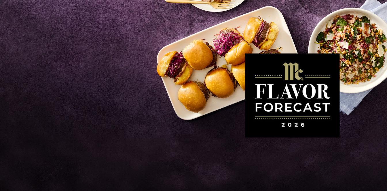 A top-down food presentation on a dark purple textured background, featuring a white rectangular platter with golden-brown mini rolls and purple cabbage, a bowl of mixed salad, and a black square overlay reading 'McFlavor Forecast 2026'.
