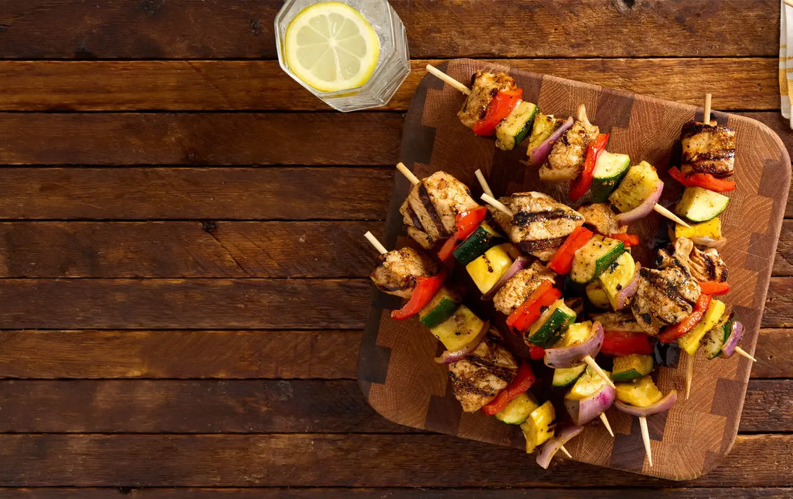 Sweet Mesquite Chicken And Vegetable Kabobs on a wooden table