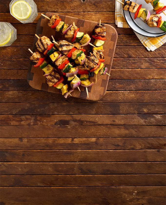 Sweet Mesquite Chicken And Vegetable Kabobs on a wooden table