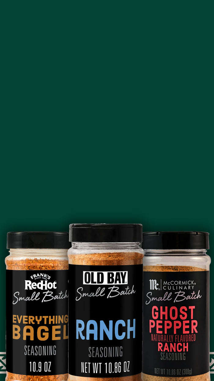 Three seasoning bottles labeled on a green background