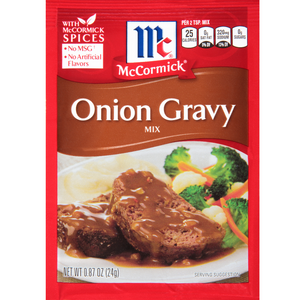McCormick Onion Gravy Mix packet with a dish of meatloaf and vegetables on a white background