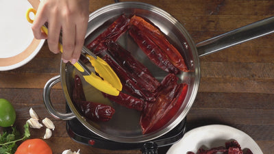 chili pods toasted on a pan in a kitchen