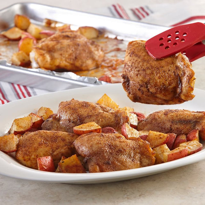 A plate of roasted chicken thighs and potatoes.