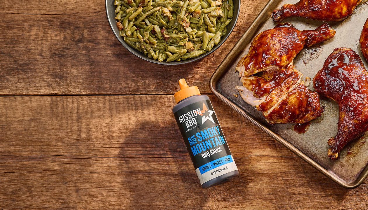 blue ridge smoky mountain sauce on a table with chicken covered in sauce