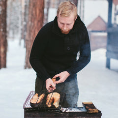 person grilling in winter